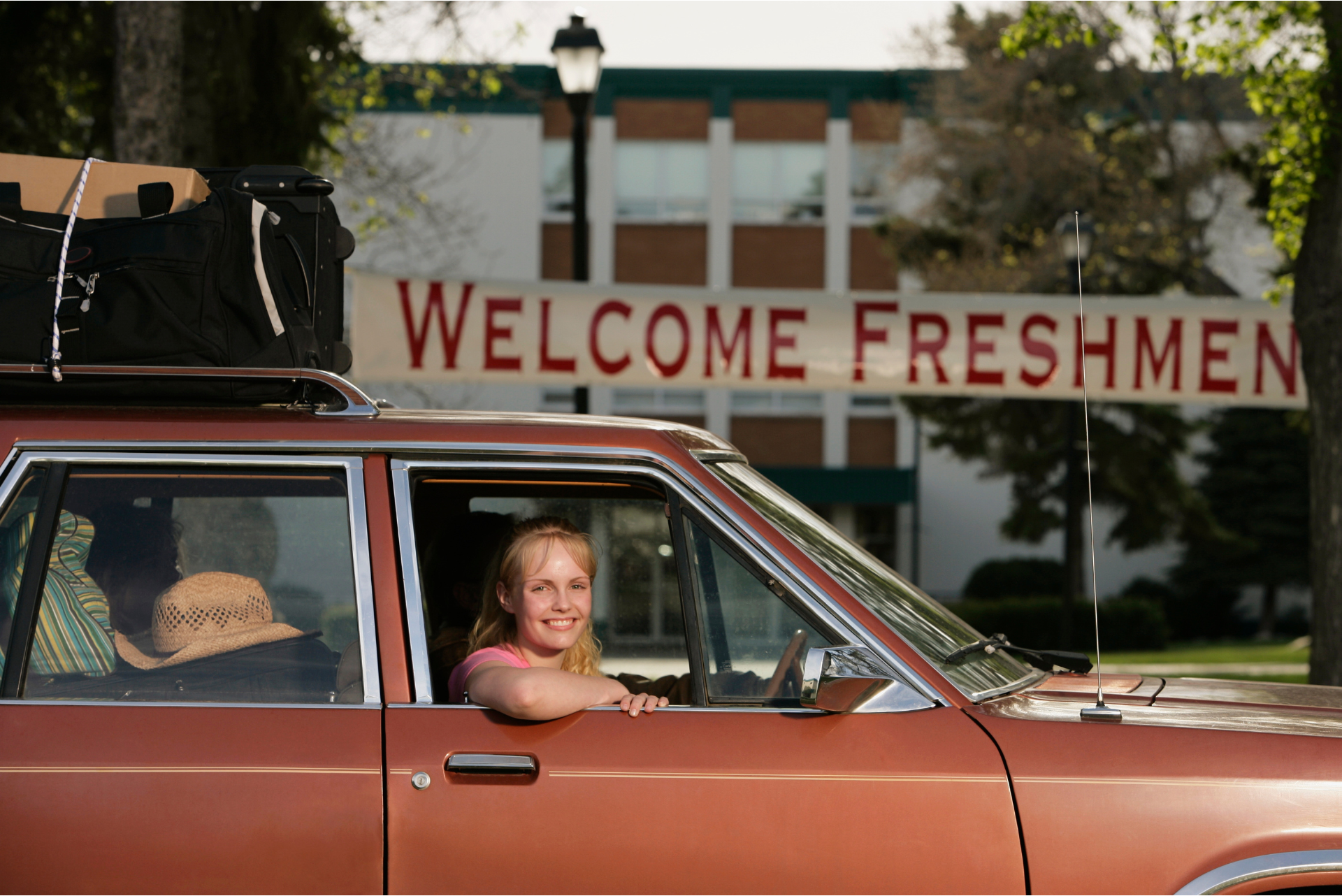 Image of parent in car in front of college