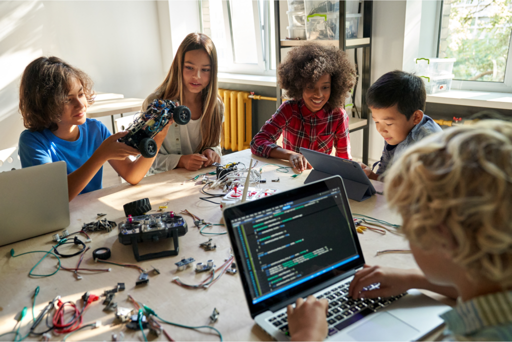 Kids building with coding toys.